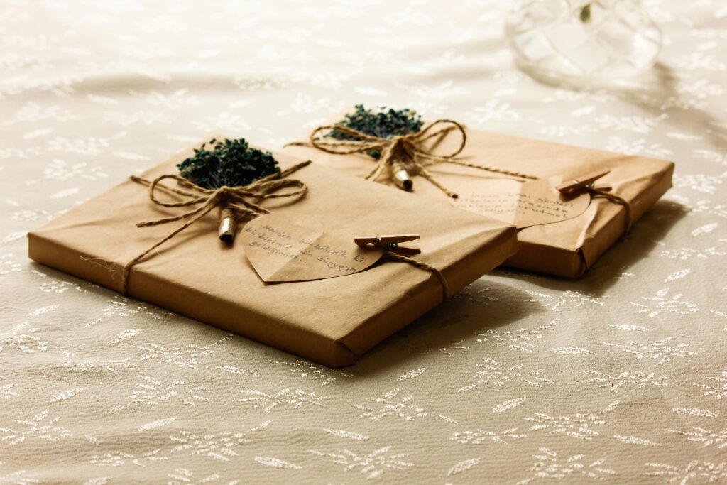 Two beautifully wrapped gift packages with twine and decorative elements, ideal for special occasions.